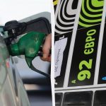 Паливний пістолет на тлі автомобільної заправки з цінниками на бензин і дизель